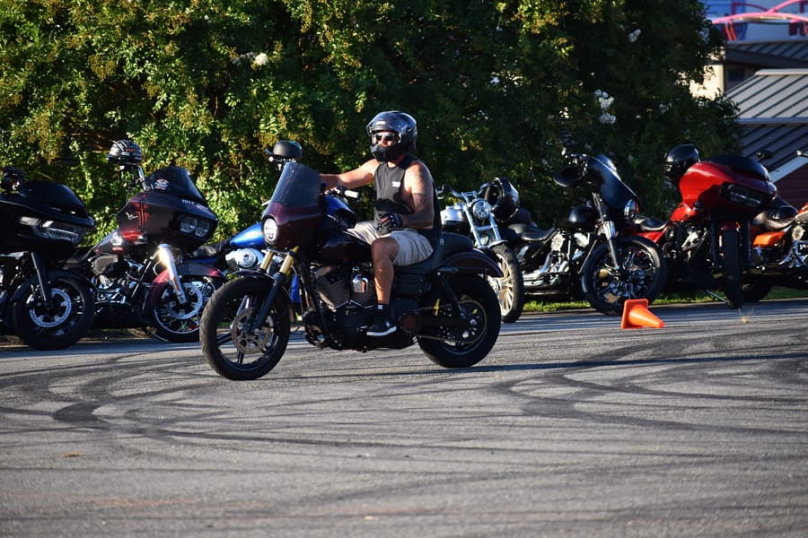 Rider hanging out by his bike at Bike Night at Eats on 601 in Mocksville NC