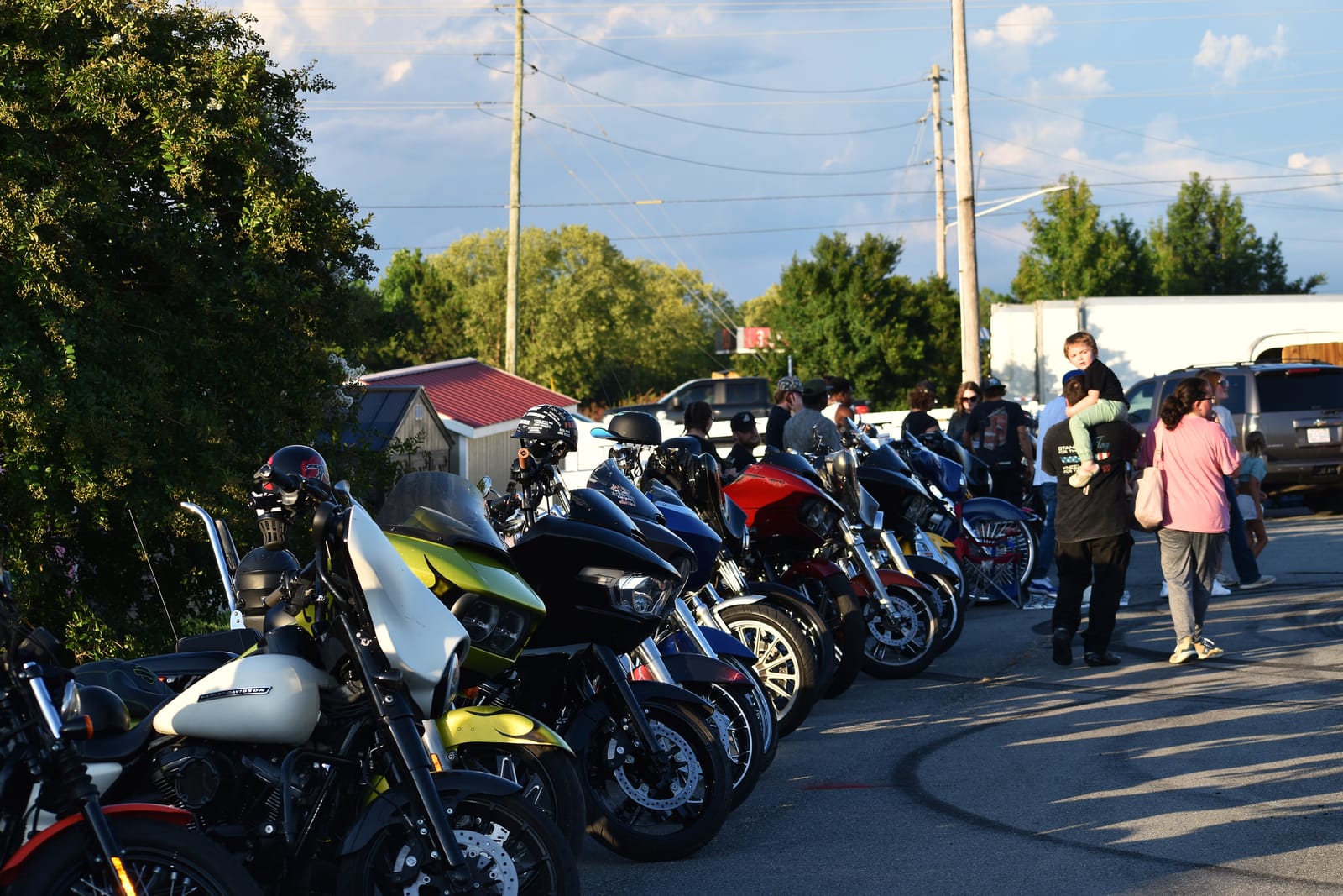 Bikes filling the lot under a dusk sky at the Eats on 601 Bike Night