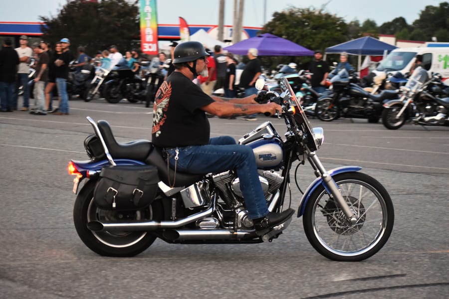 Rider hanging out by his bike at Bike Night at Eats on 601 in Mocksville NC