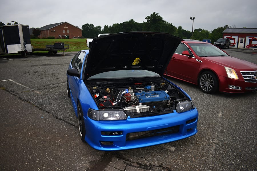 Boosted blue Honda Del Sol parked at the Honda car meet at Eats on 601 in Mocksville NC