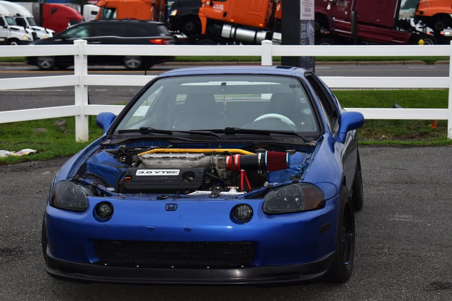 Boosted blue Honda Del Sol parked at the Honda car meet at Eats on 601 in Mocksville NC