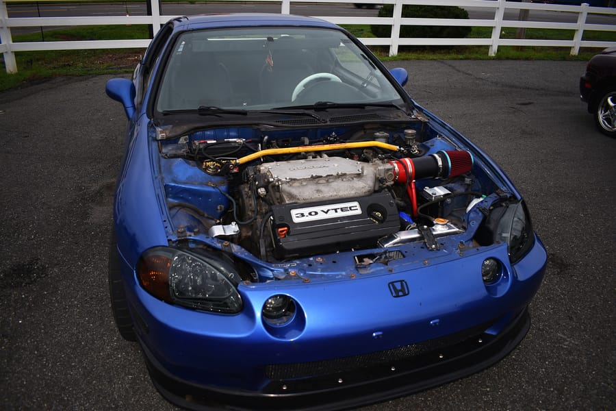 Boosted blue Honda Del Sol parked at the Honda car meet at Eats on 601 in Mocksville NC